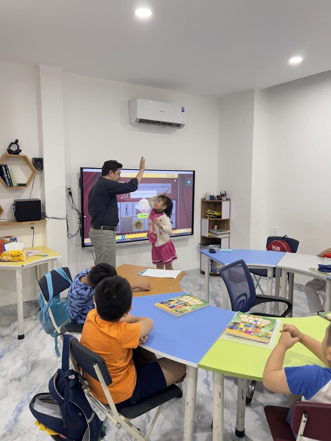 Students raising hands in a Stemhouse class